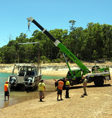 Crane lowering boat